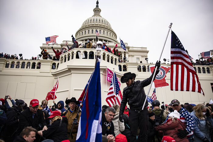 Crowd gathered outside the Capitol with flags and hats during the January 6 event, related to Trump called Pence wimp notes. Crowd gathered outside the Capitol with flags and hats during the January 6 event, related to Trump called Pence wimp notes.