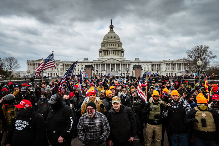 Crowd outside US Capitol on January 6 with flags and hats, related to prosecutors called mob of rioters placed on leave by DOJ Crowd outside US Capitol on January 6 with flags and hats, related to prosecutors called mob of rioters placed on leave by DOJ