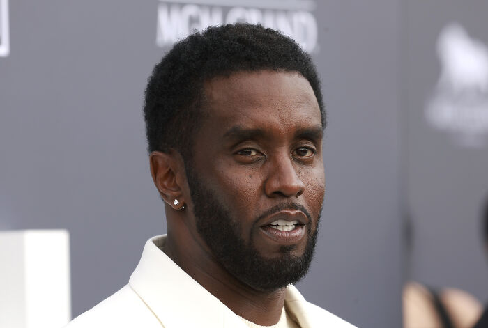 Diddy wearing a white suit jacket at an event, relating to White House response on Trump-Diddy report.