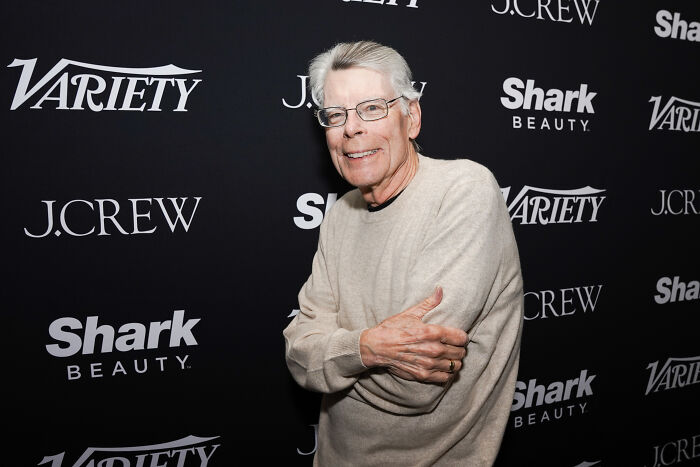 Stephen King wearing glasses and a beige sweater at a media event, linked to World Series Truth Social post controversy. Stephen King wearing glasses and a beige sweater at a media event, linked to World Series Truth Social post controversy.