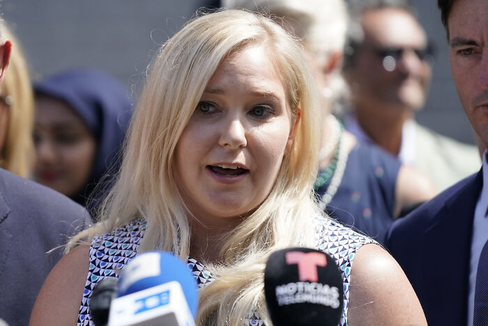 Virginia Giuffre speaking at a press conference with microphones, discussing allegations involving a well-known prime minister.
