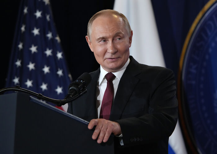 Vladimir Putin speaking at a podium with American and Russian flags, Russian leader flexes his nukes. Vladimir Putin speaking at a podium with American and Russian flags, Russian leader flexes his nukes.