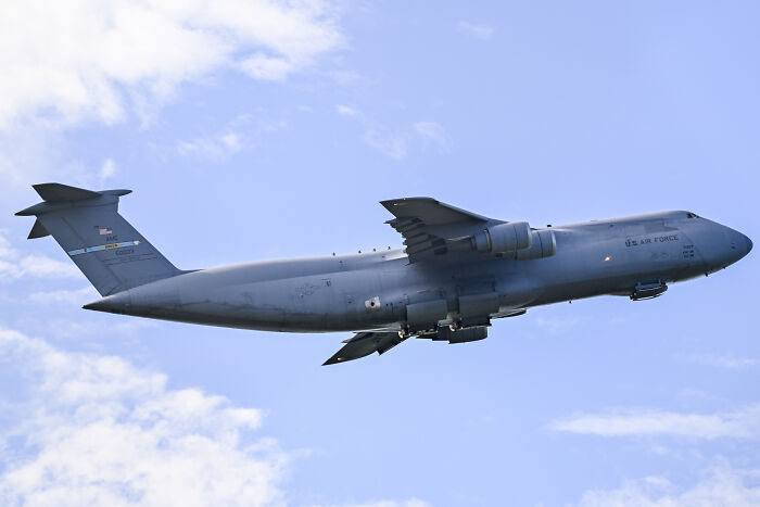 US Air Force cargo plane flying in clear sky amid skyrocketing tensions between US and Venezuela. US Air Force cargo plane flying in clear sky amid skyrocketing tensions between US and Venezuela.