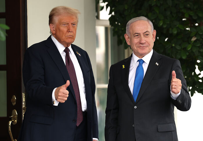 Former President Trump and Israeli leader giving thumbs up, related to Hamas hostage release and ceasefire doubts.