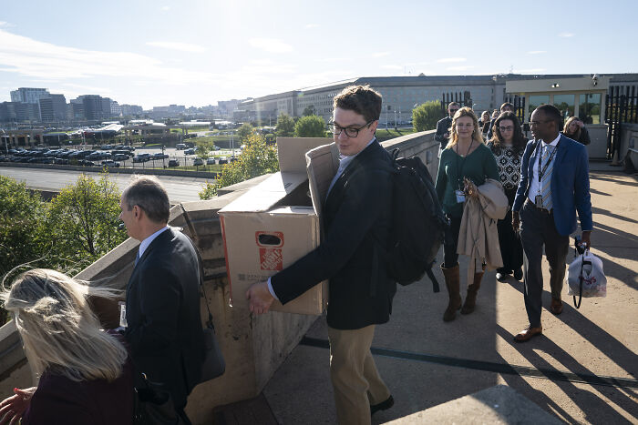 Government employees carrying boxes and leaving a federal building during a government shutdown in Washington DC Government employees carrying boxes and leaving a federal building during a government shutdown in Washington DC