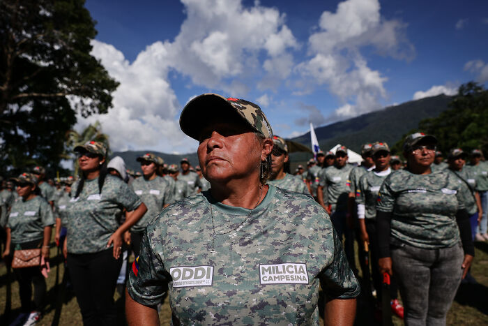 Venezuelan militia members in camouflage uniforms standing outdoors amid rising tensions with the U.S. Venezuelan militia members in camouflage uniforms standing outdoors amid rising tensions with the U.S.