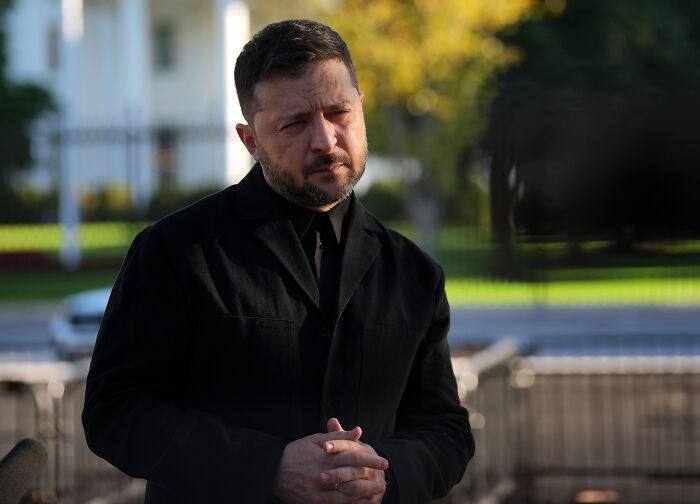 A man in a black coat speaking outdoors with a serious expression, news related to Russian leader flexing nukes. A man in a black coat speaking outdoors with a serious expression, news related to Russian leader flexing nukes.