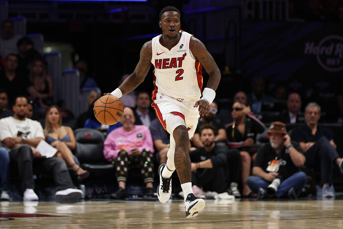 NBA player in Heat uniform dribbling the ball during a game, highlighting insider bets and rigged gambling cases. NBA player in Heat uniform dribbling the ball during a game, highlighting insider bets and rigged gambling cases.
