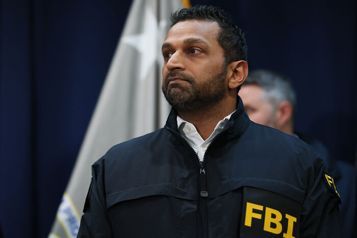 FBI agent in a black jacket at a press conference discussing NBA gambling cases involving mafia money and rigged games. FBI agent in a black jacket at a press conference discussing NBA gambling cases involving mafia money and rigged games.