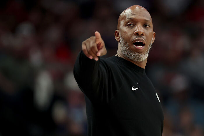 Man in black Nike shirt gesturing during an NBA game related to FBI dual NBA gambling cases and insider bets. Man in black Nike shirt gesturing during an NBA game related to FBI dual NBA gambling cases and insider bets.