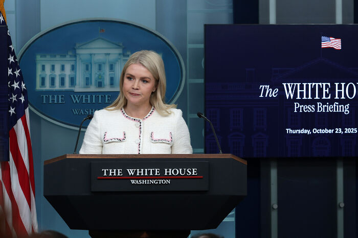 Woman at The White House podium during a press briefing, related to Trump’s granddaughter revealing his hand problems timeline. Woman at The White House podium during a press briefing, related to Trump’s granddaughter revealing his hand problems timeline.