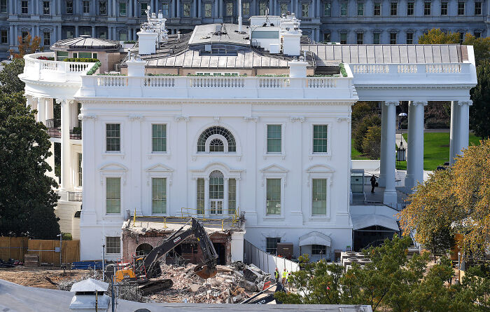 View of White House renovations in progress with construction equipment and workers amid controversy in D.C. projects oversight. View of White House renovations in progress with construction equipment and workers amid controversy in D.C. projects oversight.