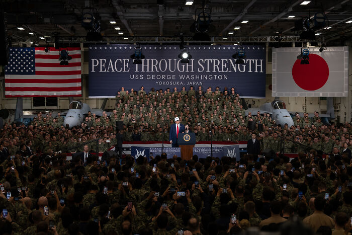 Donald Trump speaking aboard USS George Washington aircraft carrier in front of military personnel during a speech about magnets and steam. Donald Trump speaking aboard USS George Washington aircraft carrier in front of military personnel during a speech about magnets and steam.