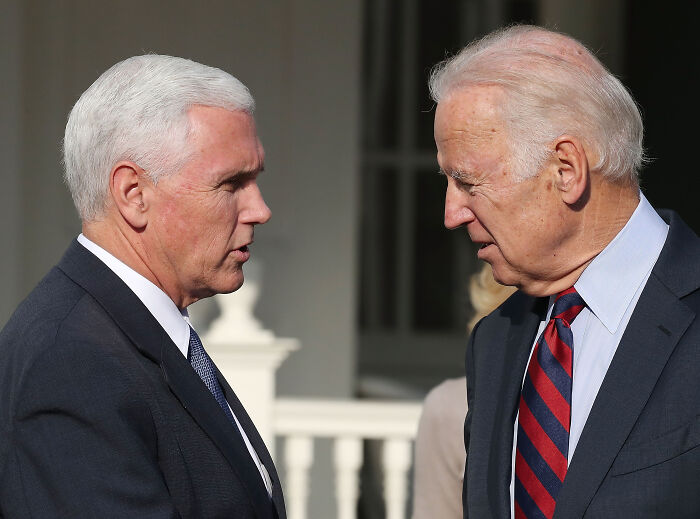 Mike Pence and Joe Biden engaged in a serious conversation outdoors, related to Trump called Pence wimp January 6 notes. Mike Pence and Joe Biden engaged in a serious conversation outdoors, related to Trump called Pence wimp January 6 notes.