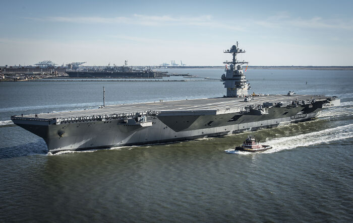 U.S. Navy’s largest aircraft carrier sailing with escort boat near coastline amid rising Caribbean tensions. U.S. Navy’s largest aircraft carrier sailing with escort boat near coastline amid rising Caribbean tensions.