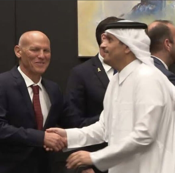 Two men shaking hands representing diplomatic talks amid doubts over Israel’s ceasefire and Hamas hostage release claims.