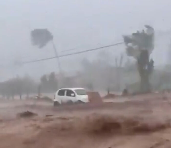 Flooded street with a white car partially submerged during Hurricane Melissa devastation in Jamaica with strong winds and heavy rain. Flooded street with a white car partially submerged during Hurricane Melissa devastation in Jamaica with strong winds and heavy rain.