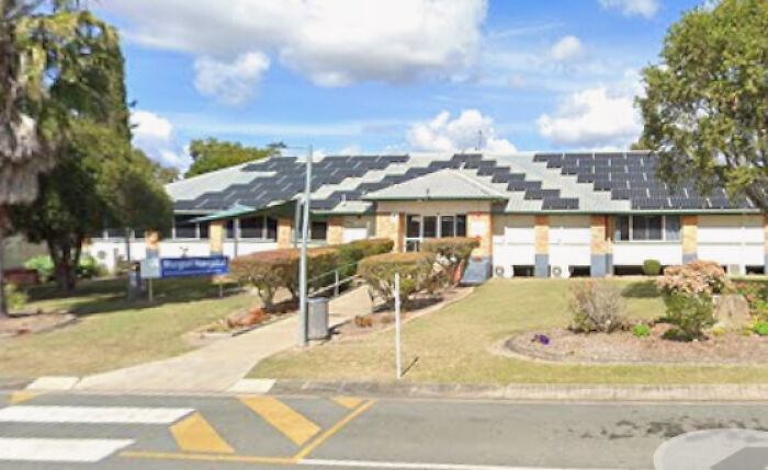 Hospital building exterior with solar panels on roof, related to dad thinking son was drinking alcohol and told him to sleep it off. Hospital building exterior with solar panels on roof, related to dad thinking son was drinking alcohol and told him to sleep it off.
