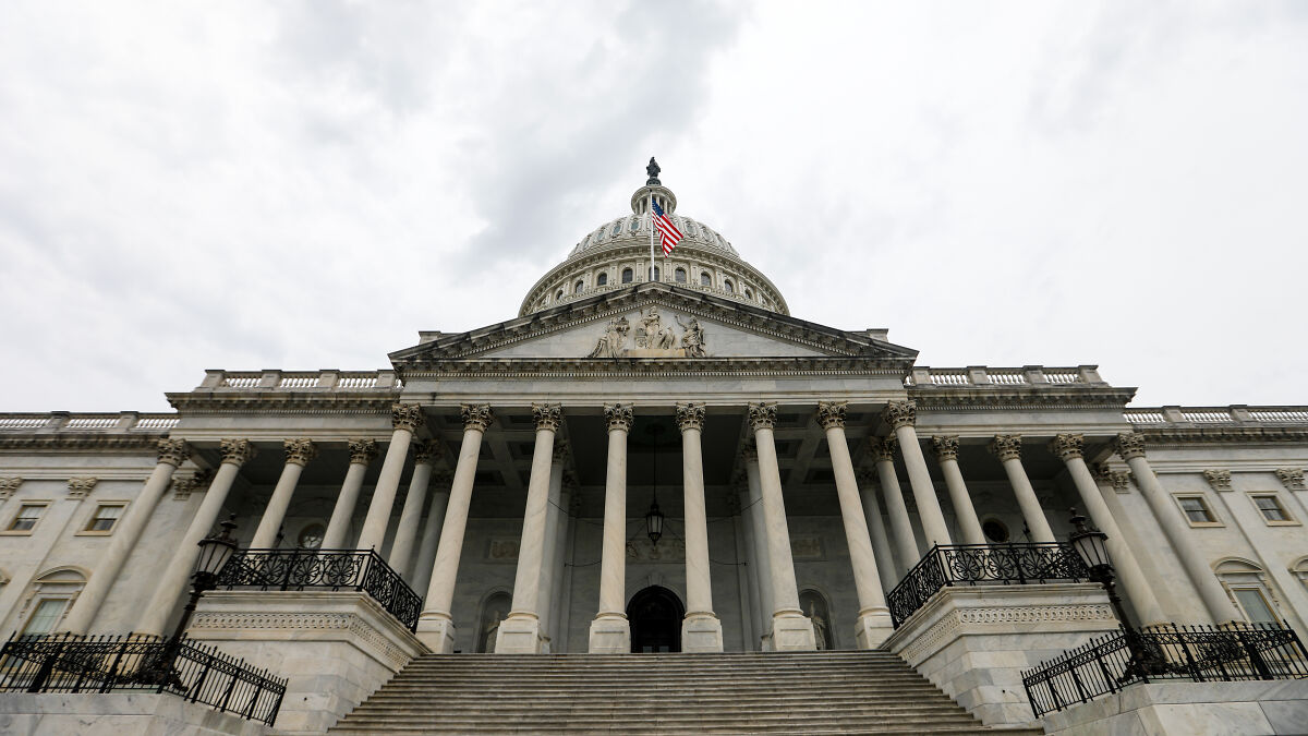 View of the U.S. Capitol building with cloudy sky, symbolizing recent U.S. government shutdowns and political events.