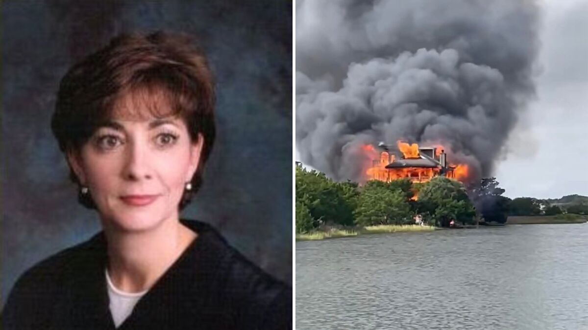 Portrait of judge next to house engulfed in flames with thick smoke rising over nearby water and trees