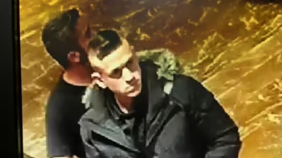 Two men indoors, one in a black jacket and sunglasses, related to Bogotu00e1u2019s Monster of Grindr fear case.