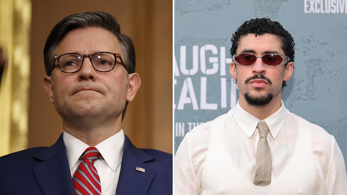 Mike Johnson wearing glasses and suit beside Bad Bunny in sunglasses and beige tie at a public event.