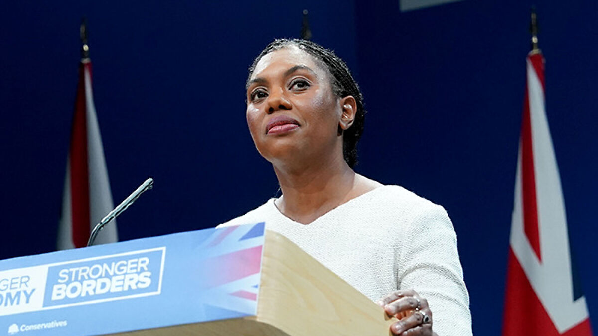 Speaker at a podium with Conservative party branding, addressing UK Conservatives human rights convention issues.