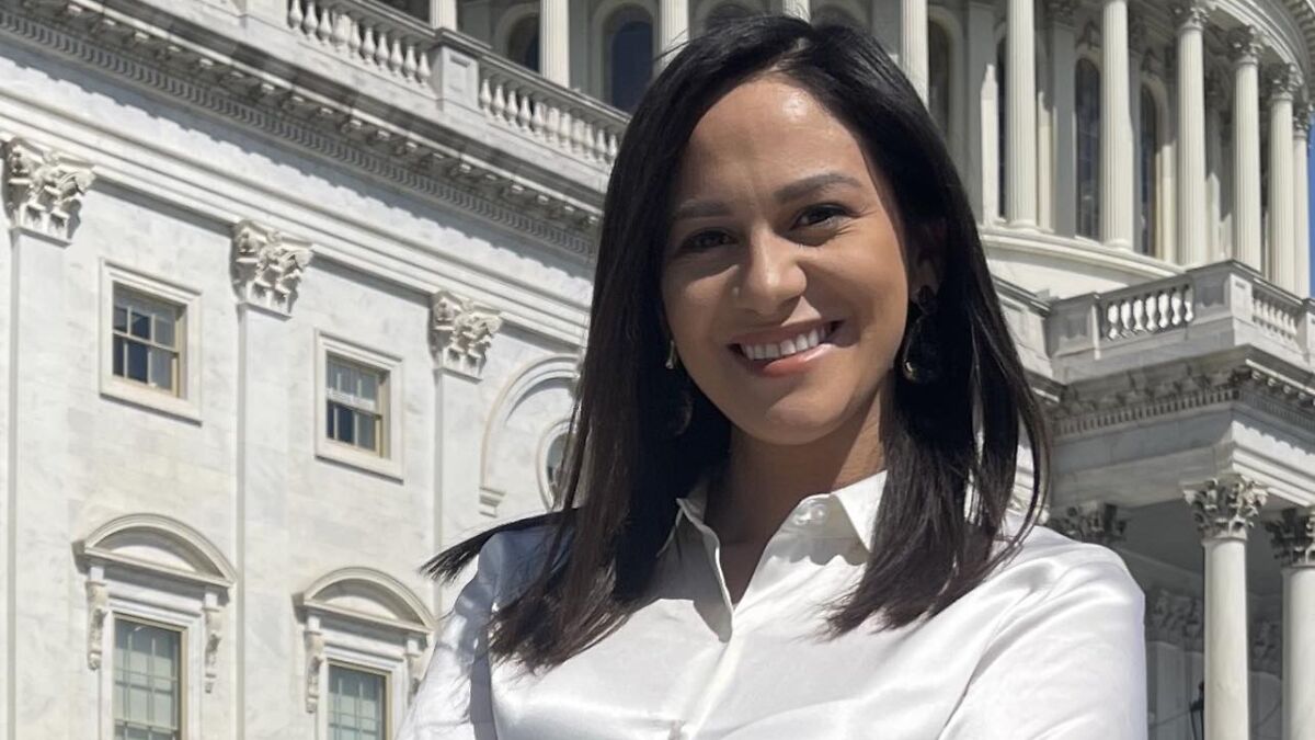 Young woman smiling in front of Capitol building, related to married congressman alleged affair with aide news story.