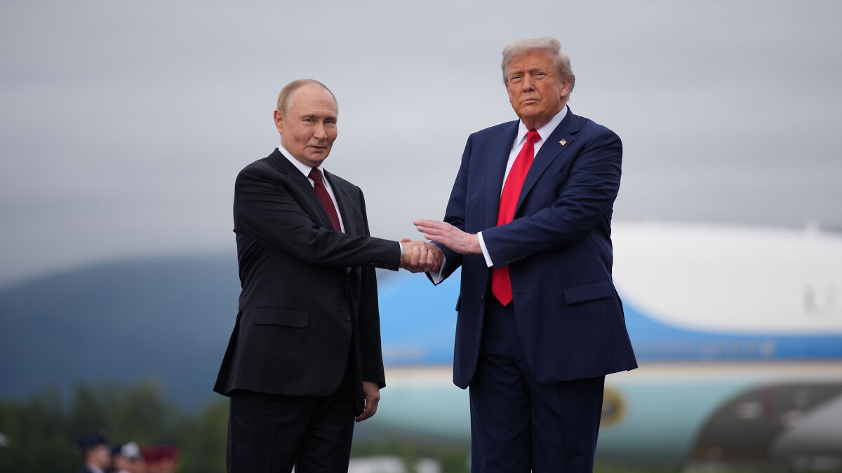 Donald Trump and Vladimir Putin shaking hands outdoors with Air Force One in the background, highlighting nuclear power tensions.