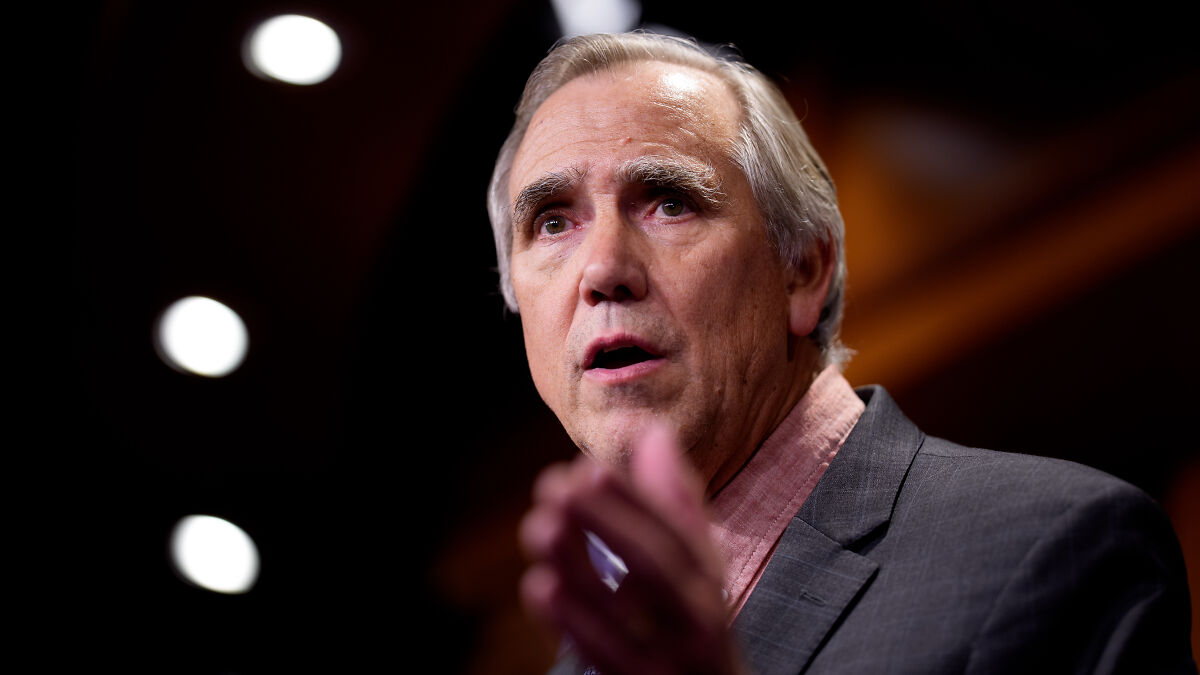 Senator delivering a floor speech warning of an authoritarian takeover by Trump, appearing serious and focused.