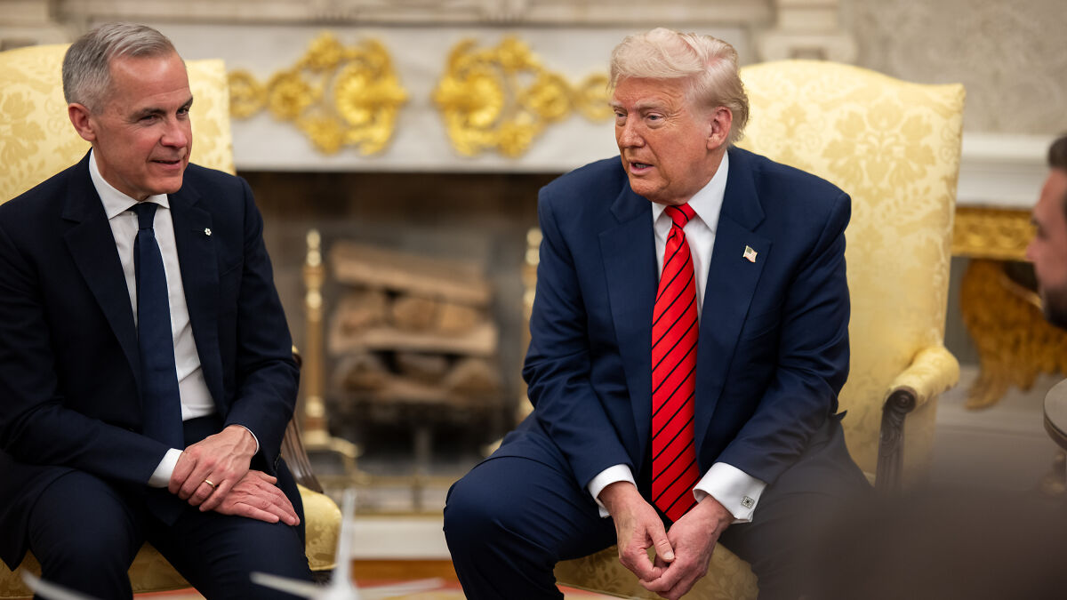 Donald Trump in a formal meeting, wearing a red striped tie, discussing trade negotiations with a Canadian official.