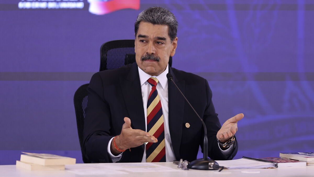 Nicolas Maduro speaking at a conference table amid skyrocketing tensions between U.S. and Venezuela.