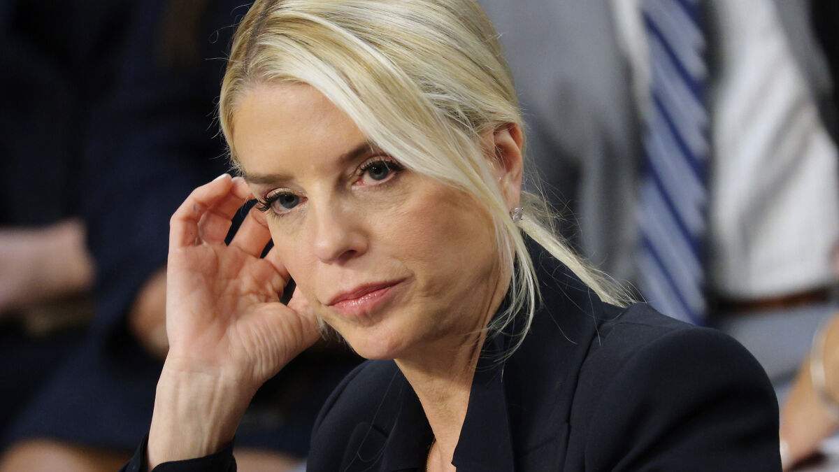Blonde woman in a black blazer, looking concerned during a public event about man arrested over $45K offer to end Pam Bondiu2019s life.