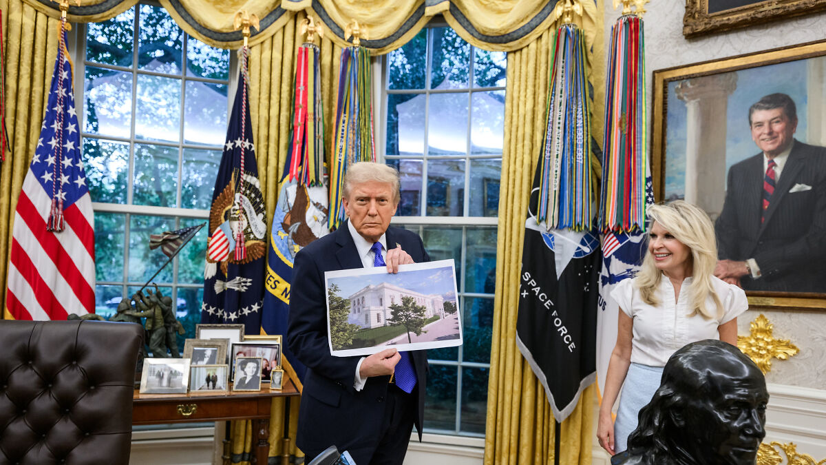 Donald Trump in the Oval Office holding a D.C. renovation plan amid controversy over agency oversight changes.
