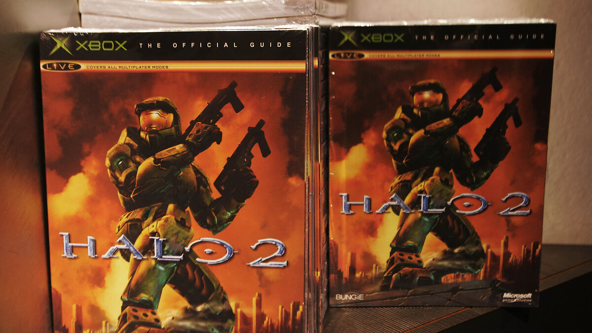 Halo 2 game cover featuring armored soldier with guns, highlighting Halo developers' response to ICE recruitment advert controversy.