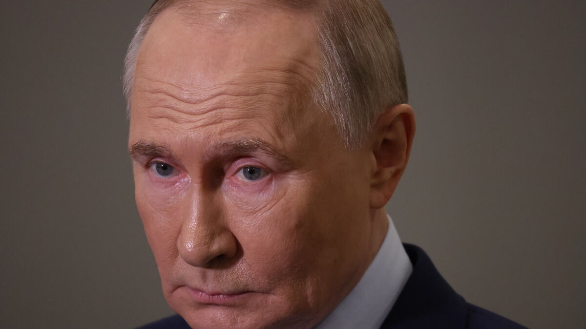 Close-up of a serious man in a suit, symbolizing Russiau2019s shadow energy economy focused on oil production and trade.