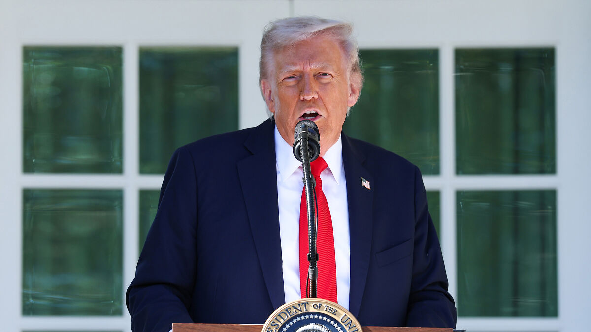 Former President Trump speaking at a podium during a press event, related to nuclear weapons testing orders.