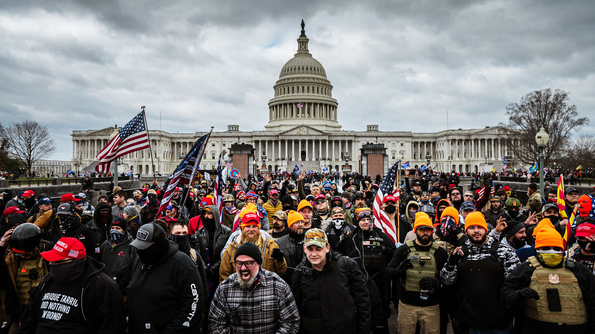 Crowd gathered near US Capitol during January 6 riot event, prosecutors who called them mob placed on leave by DOJ.