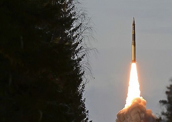 A missile launching with bright flames and smoke, illustrating Russian leader flexing his nukes in a tense moment. A missile launching with bright flames and smoke, illustrating Russian leader flexing his nukes in a tense moment.