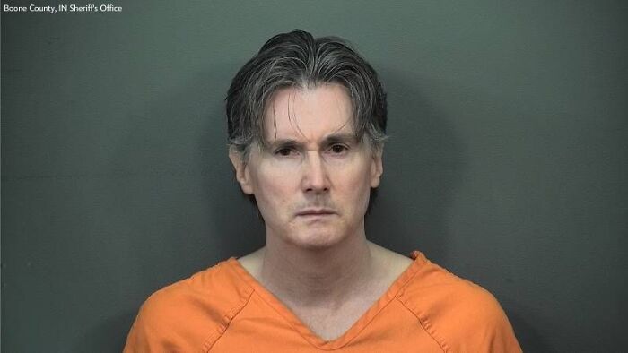 Mugshot of Indiana man charged with shooting house cleaner who arrived at the wrong home, wearing orange jail uniform. Mugshot of Indiana man charged with shooting house cleaner who arrived at the wrong home, wearing orange jail uniform.