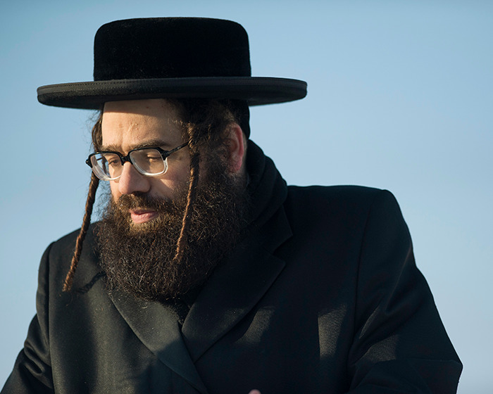 Man with beard and glasses wearing traditional attire representing Lev Tahor sect involved in police rescue of children Man with beard and glasses wearing traditional attire representing Lev Tahor sect involved in police rescue of children