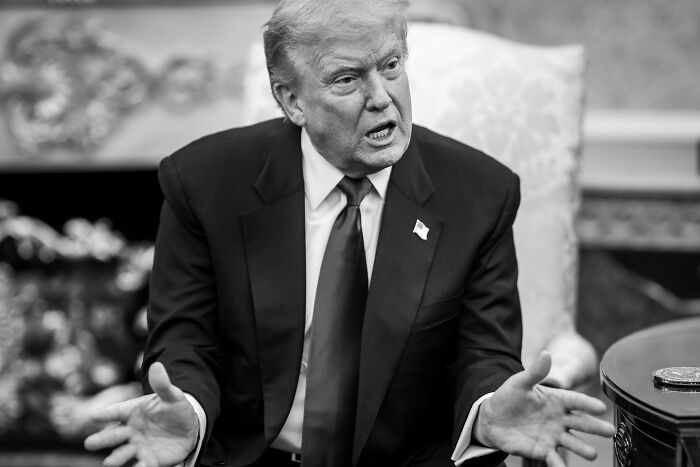 Former President Donald Trump in a suit speaking passionately during a formal meeting in a decorated room. Former President Donald Trump in a suit speaking passionately during a formal meeting in a decorated room.