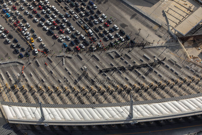 Aerial view of a crowded vehicle checkpoint with officials inspecting cars amid White House Venezuela fentanyl supply concerns. Aerial view of a crowded vehicle checkpoint with officials inspecting cars amid White House Venezuela fentanyl supply concerns.