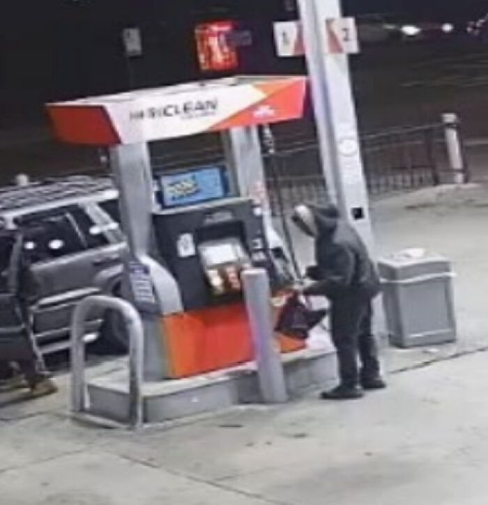 Suspect at gas station wearing a hoodie filling a red container, linked to Chicago woman set ablaze on train by repeat offender.