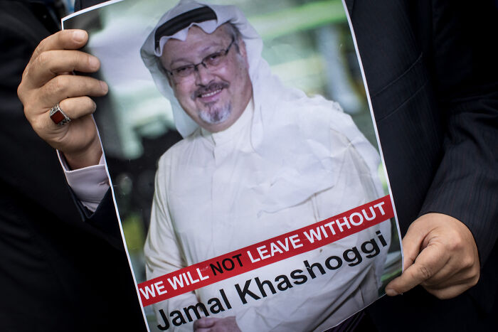 Person holding a poster of Jamal Khashoggi, related to Trump defending Saudi Prince and journalist controversy. Person holding a poster of Jamal Khashoggi, related to Trump defending Saudi Prince and journalist controversy.