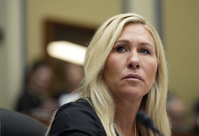 Blonde woman in a black top listening intently during a formal discussion about Trump urging GOP support on Epstein files. Blonde woman in a black top listening intently during a formal discussion about Trump urging GOP support on Epstein files.