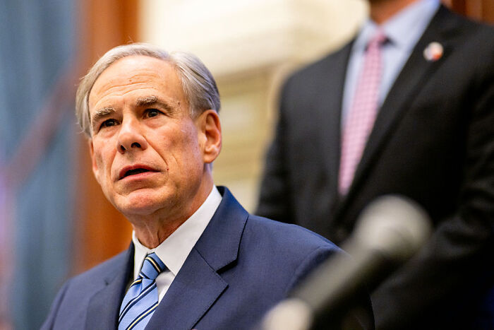 Man in suit and striped tie speaking at a formal event about Texas racially gerrymandered map and federal court ruling. Man in suit and striped tie speaking at a formal event about Texas racially gerrymandered map and federal court ruling.