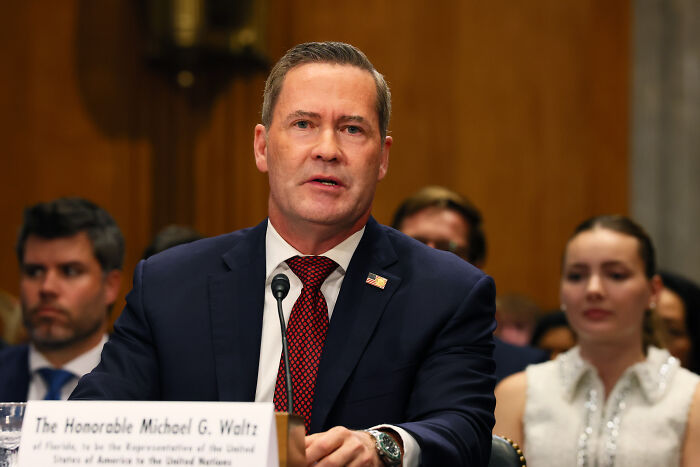 A man in a suit and tie speaking at a formal hearing, highlighting Nicki Minaj backlash involving Trump administration. A man in a suit and tie speaking at a formal hearing, highlighting Nicki Minaj backlash involving Trump administration.
