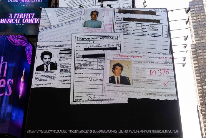 Billboard in a city showing Epstein files and contact messages amid rising pressure and Trump involvement reports.