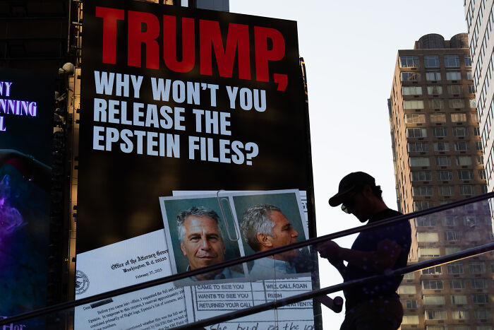 Large digital billboard in a city displays the question about Trump and the release of Epstein files during sunset. Large digital billboard in a city displays the question about Trump and the release of Epstein files during sunset.